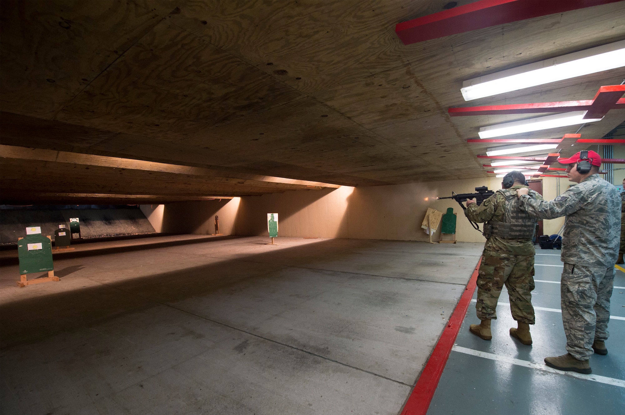 U.S. Air Force Chief Master Sgt. Ernesto Rendon, 86th Airlift Wing command chief, first an M-4 Carbine during a training session inside the 65th Security Forces Squadron’s Combat Arms Training and Maintenance building at Lajes Air Field, Azores, Jan. 30, 2019. The M-4 Carbine is a selective-fire rifle featuring both semi-automatic firing mode and automatic. (U.S. Air Force photo by Staff Sgt. Jonathan Bass)