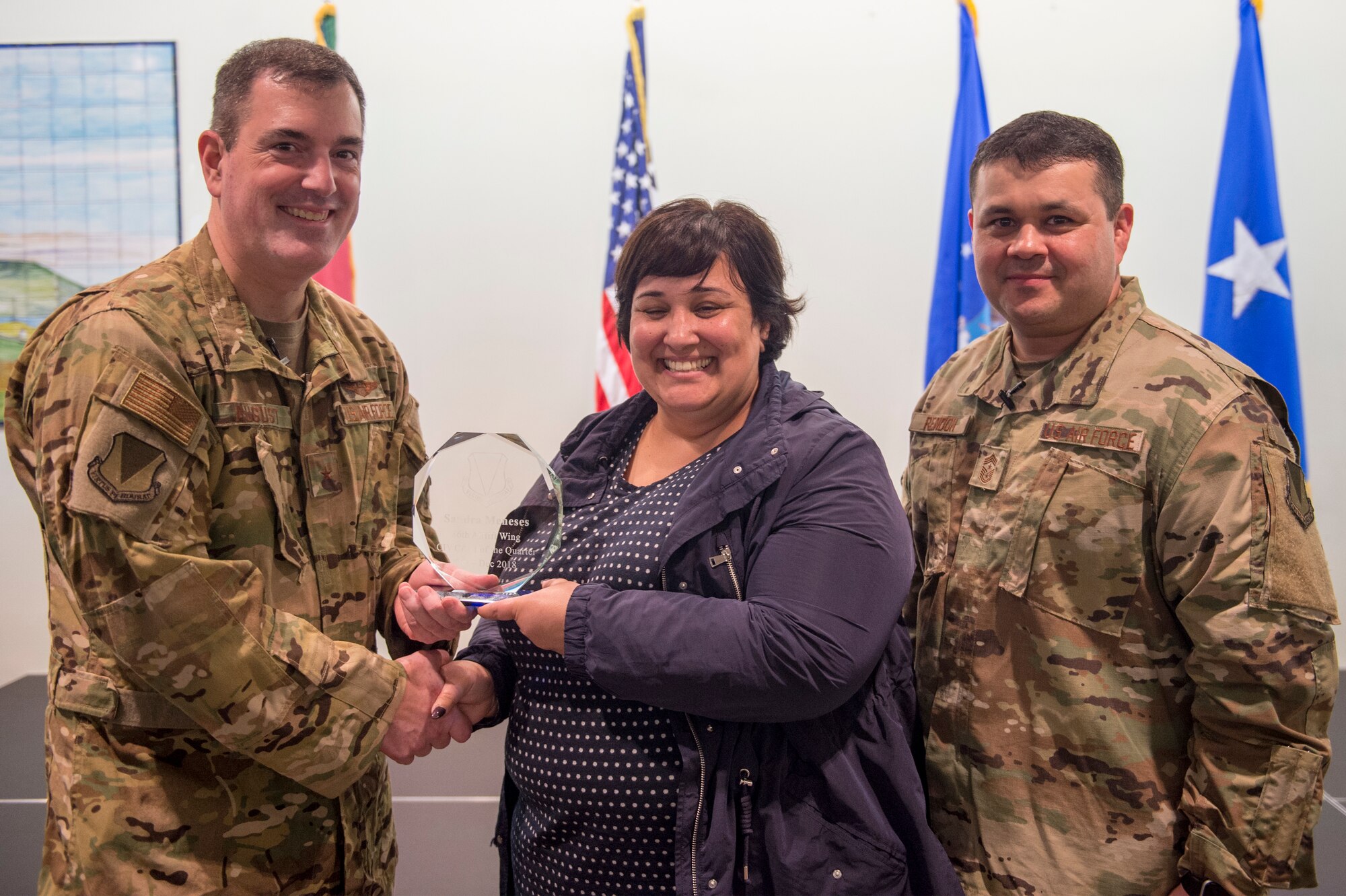Sandra Morales, 65th Logistics Readiness Squadron supply technician, receives her 86th Airlift Wing civlian category one quarterly award during an all-call at Lajes Air Field, Azores, Jan. 30, 2019. Since Morales won at the wing level, she will now compete at the Major Command level. (U.S. Air Force photo by Staff Sgt. Jonathan Bass)
