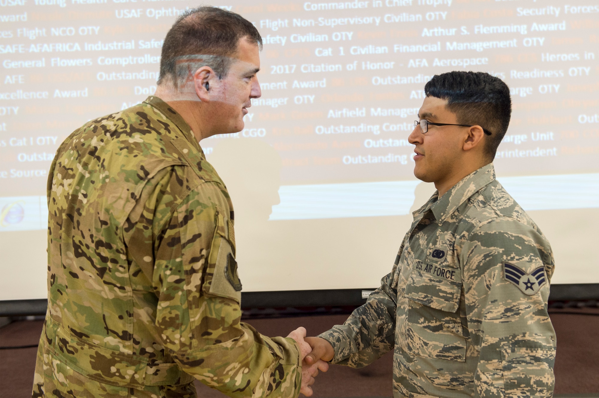 U.S. Air Force Senior Airman Ramiro Rios Jr., 496th Air Base Squadron fuels service technician (right), receives a coin from U.S. Air Force Brig. Gen. Mark R. August, 86th Airlift Wing commander (left) during an all-call on Moròn Air Base, Spain, Jan. 31, 2019. Rios was recognized by August as one of the 86th AW’s Airlifters of the Week. (U.S. Air Force photo by Staff Sgt. Jonathan Bass)