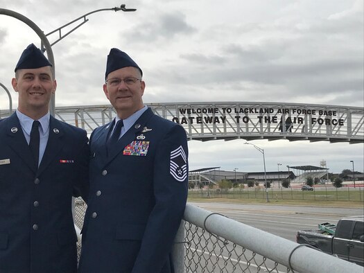 U.S. Air Force Airman 1 Class Tyler Mercer, left, and his father, Air Force Reserve Chief Master Sgt. Mark Mercer, pose for a photo near the entrance to Lackland Air Force Base, Texas, Jan. 25, 2019.