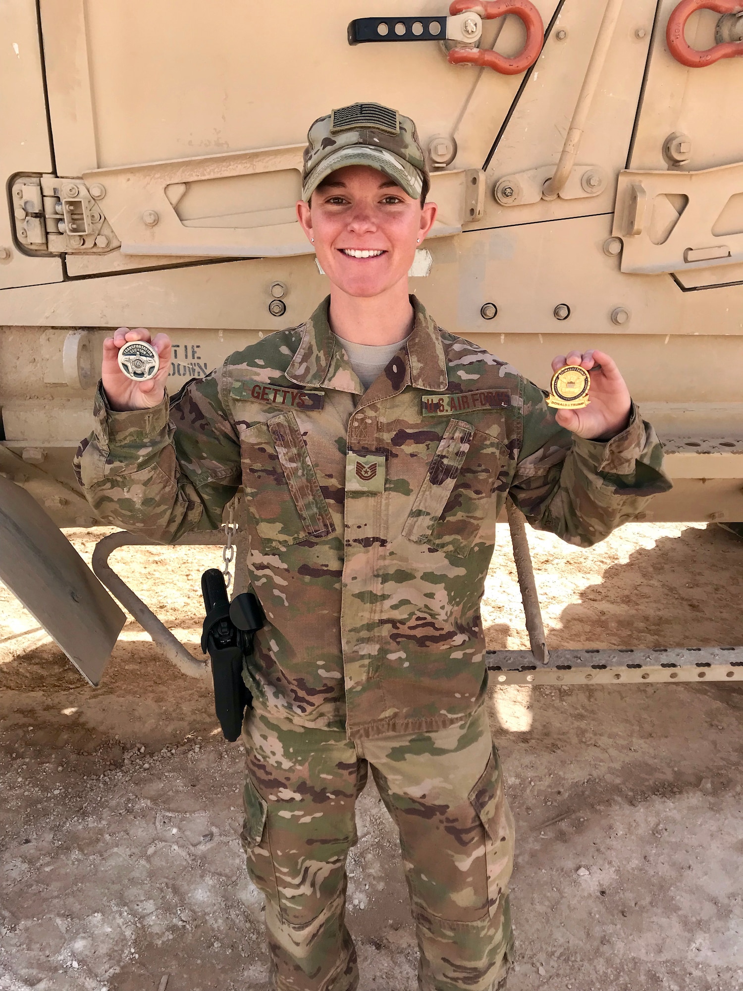 Tech. Sgt. Dawn Gettys, 445th Security Forces Squadron, shows off coins she received for the support she provided during the presidential visit to Al Asad Air Base, Iraq. Gettys was the command and control lead for the presidential motorcade during U.S. President Donald Trump and first lady Melania Trump’s visit, December of 2018.  She worked directly with the Secret Service and Naval Special Warfare Seal Team to plan the visit. (Courtesy photo)