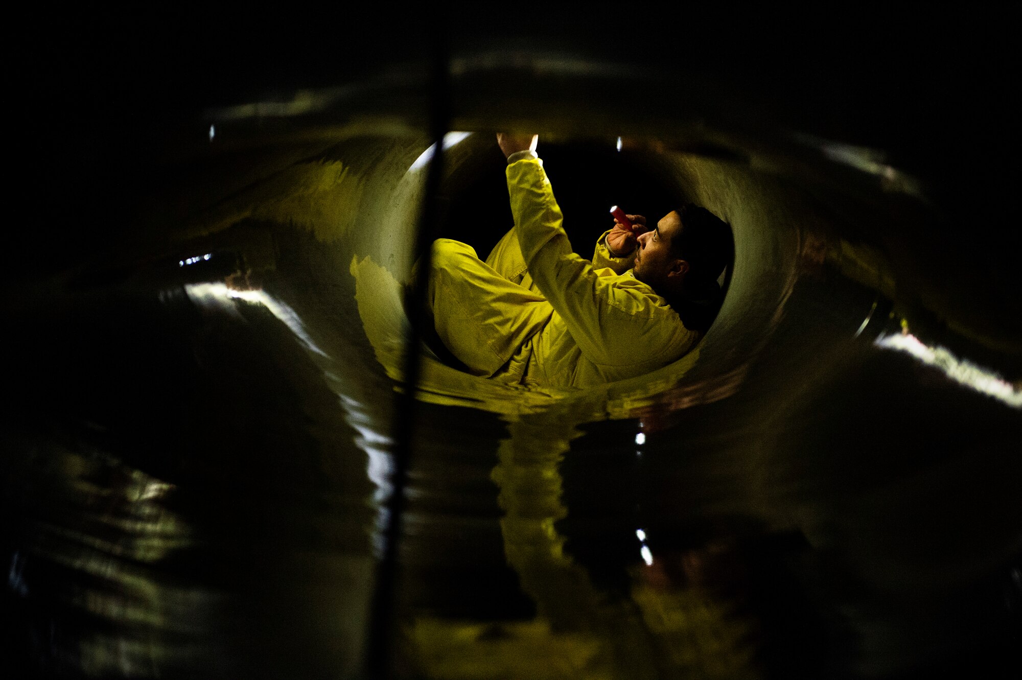 Load crews communicate through hand signals while loading pods, tanks, and missiles.