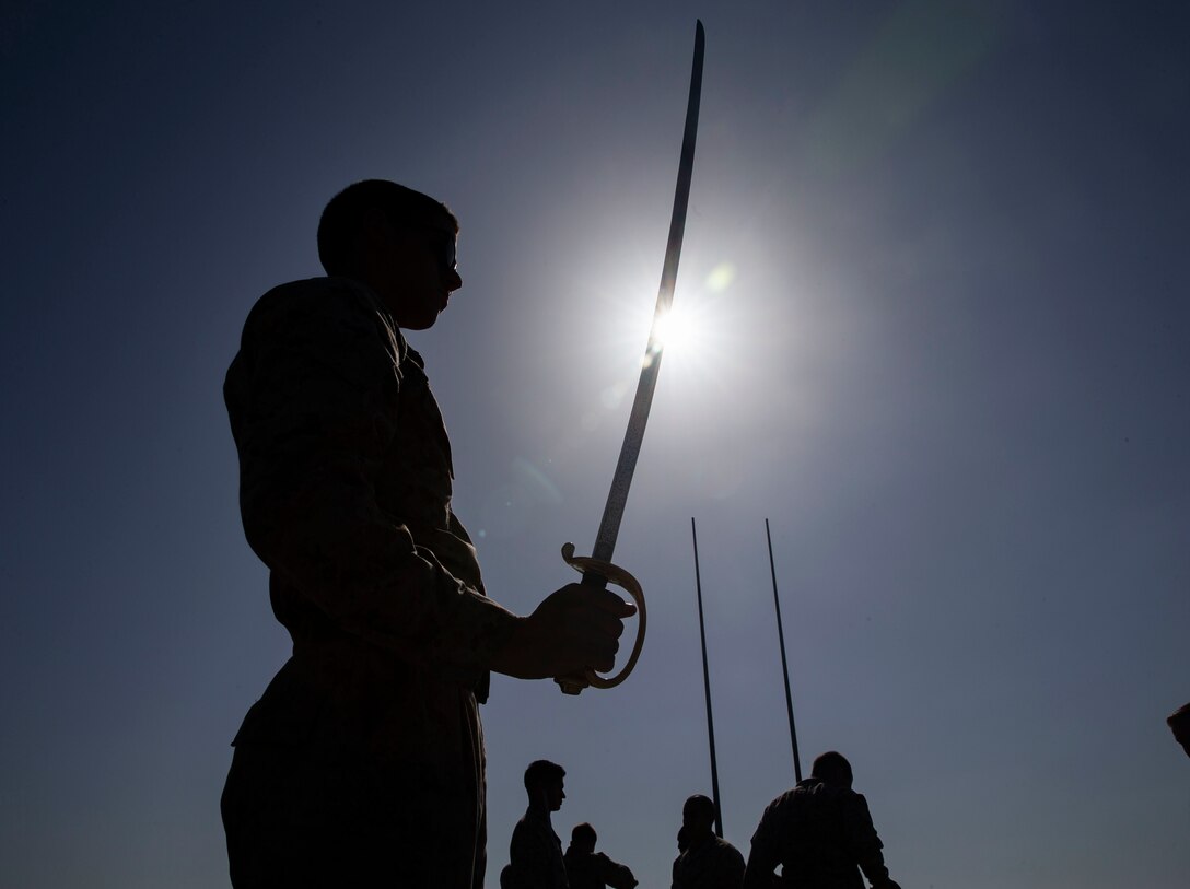U.S. Marine Corps Cpl. Neil Christner, a motor transportation operator, with the 22nd Marine Expeditionary Unit, practices sword movements during corporals course on the flight deck of the Whidbey Island-class dock landing ship USS Fort McHenry. Corporals course teaches Marines the fundamentals of being a noncommissioned officer. Marines and Sailors with the 22nd MEU and Kearsarge Amphibious Ready Group are currently deployed to the U.S. 5th Fleet area of operations in support of naval operations to ensure maritime stability and security in the Central Region, connecting the Mediterranean and the Pacific through the western Indian Ocean and three strategic choke points.