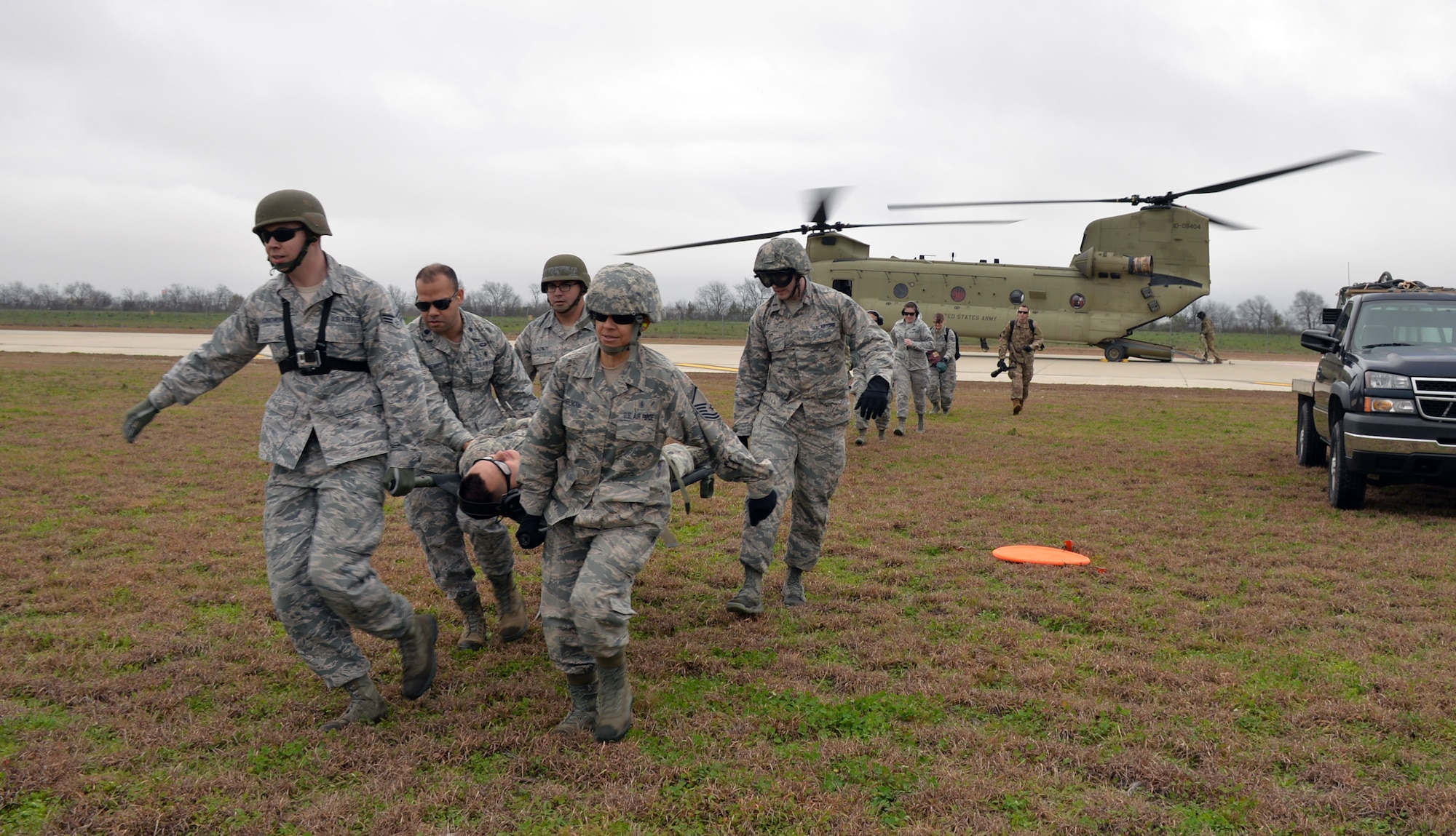 A 433rd Airlift Wing Reserve Citizen Airmen medical team carries a simulated patient away from an idling Texas Army National Guard CH-47 Chinook during Operation Dust Storm Feb. 1, 2019 at Martindale Army Air Field, Texas.