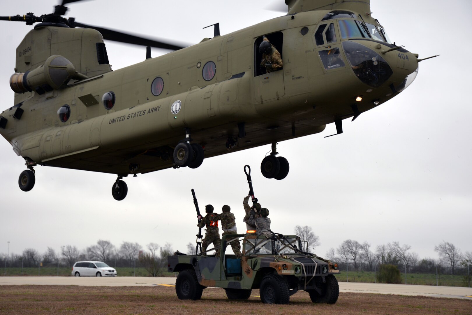 A ground crew prepares to hook a Humvee to a Texas Army National Guard CH-47 Chinook for airlifting during Operation Dust Storm at Martindale Army Air Field, Texas Feb. 1, 2019.