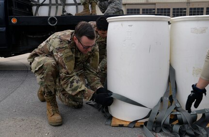 Joint, total-force Operation Dust Storm team members Tech Sgt. Charles Cate, 26th Aerial Port Squadron loadplanner, and Airman 1st Class Ernesto Contreras III, 74th APS air transportation specialist, build-up the sling-load package Feb. 1, 2019 at Martindale Army Air Field, Texas.