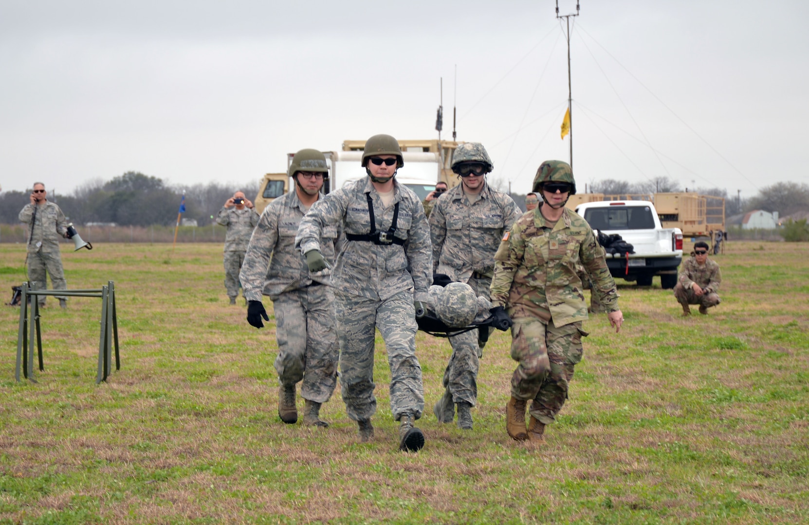 A joint, Air Force and Army medical team carries a simulated patient to an idling Texas Army National Guard CH-47 Chinook during Operation Dust Storm Feb. 1, 2019 at Martindale Army Air Field, Texas.