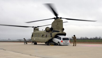 An Army National Guardsman guides a simulated ambulance out of a CH-47 Chinook during Operation Dust Storm Feb. 1, 2019 at Martindale Army Air Field, Texas.