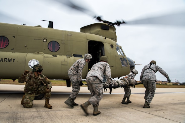 Airmen from the 433rd Medical Group perform a litter carry from a CH-47 Chinook assigned to the Texas Army National Guard, during a training exercise at Martindale Army Airfield, San Antonio, TX, Feb 1, 2019.