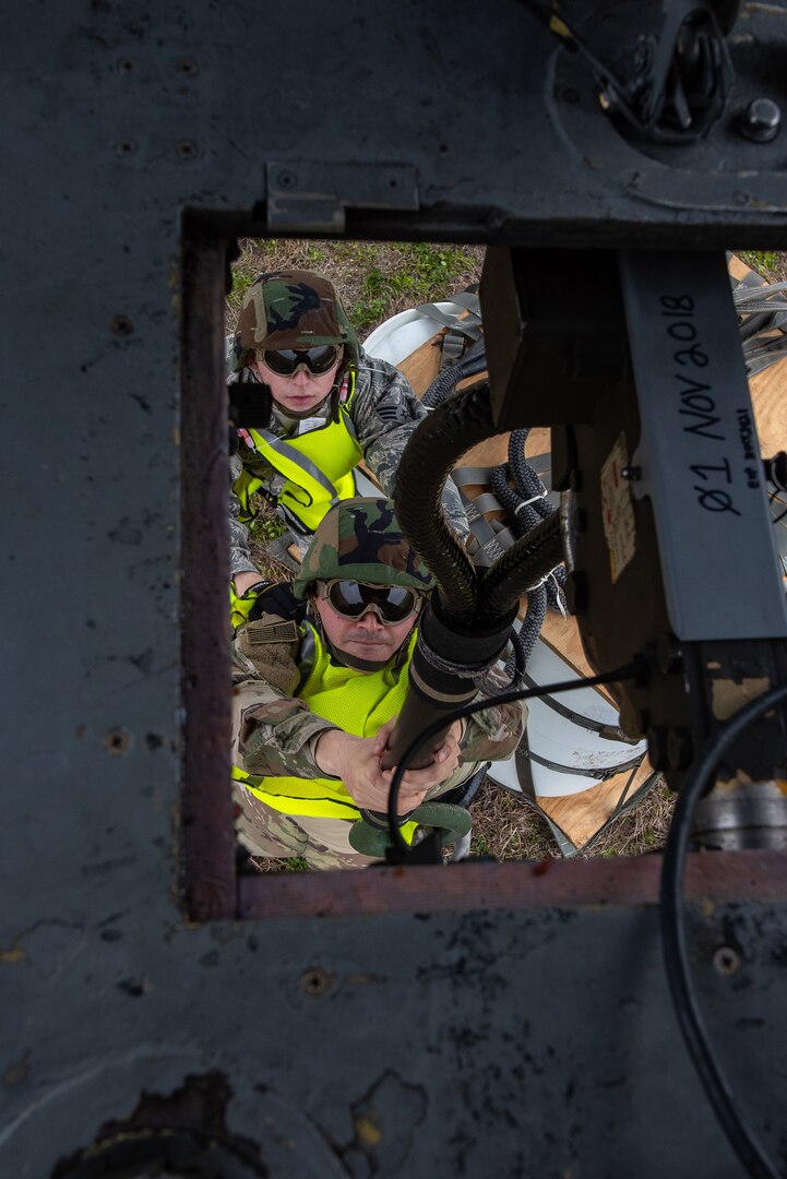 Staff Sgt. Jose Frias, aerial transportation technician, 26th Aerial Port Squadron, secures a 2,000-pound piece of cargo to a UH-60 Black Hawk helicopter flown by Soldiers from the Texas Army National Guard, Company C, 2-149 Aviation Regiment, during a sling load training event on Feb. 1, 2019, at Martindale Army Airfield, San Antonio, Texas.