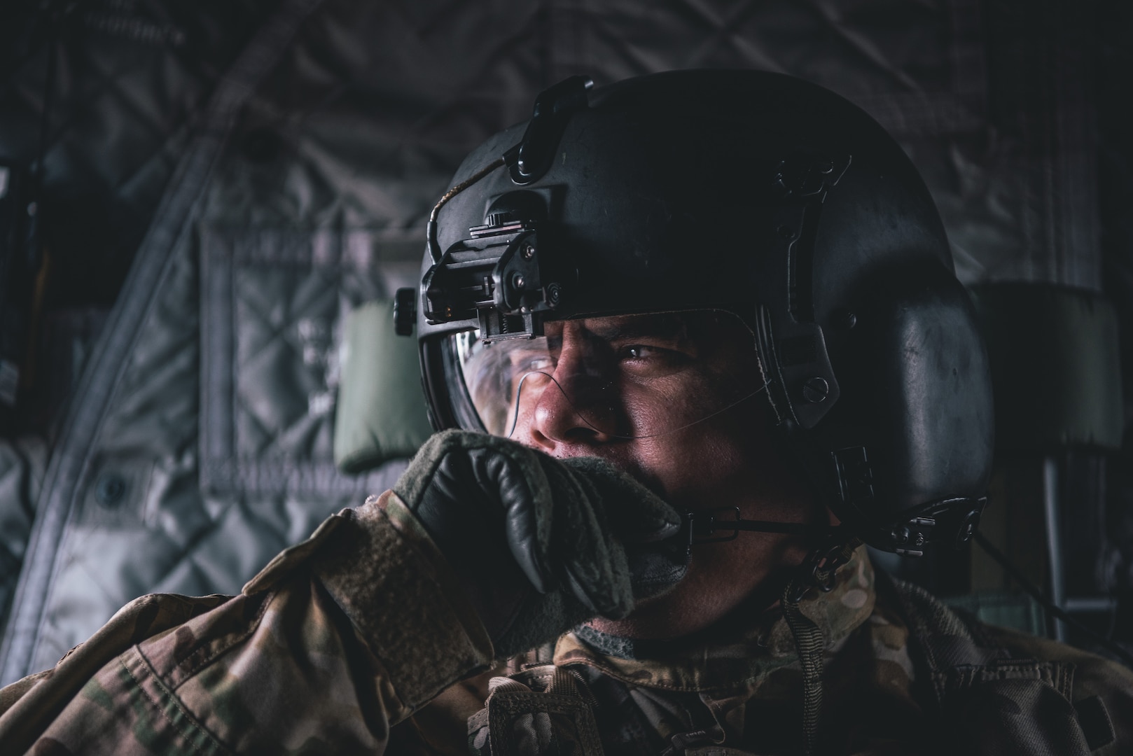 Sergeant Manuel Acevedo uses his headset to communicate with additional aircrew members of a CH-47 Chinook helicopter at Kelly Field Annex, San Antonio, TX, Feb 1, 2019.