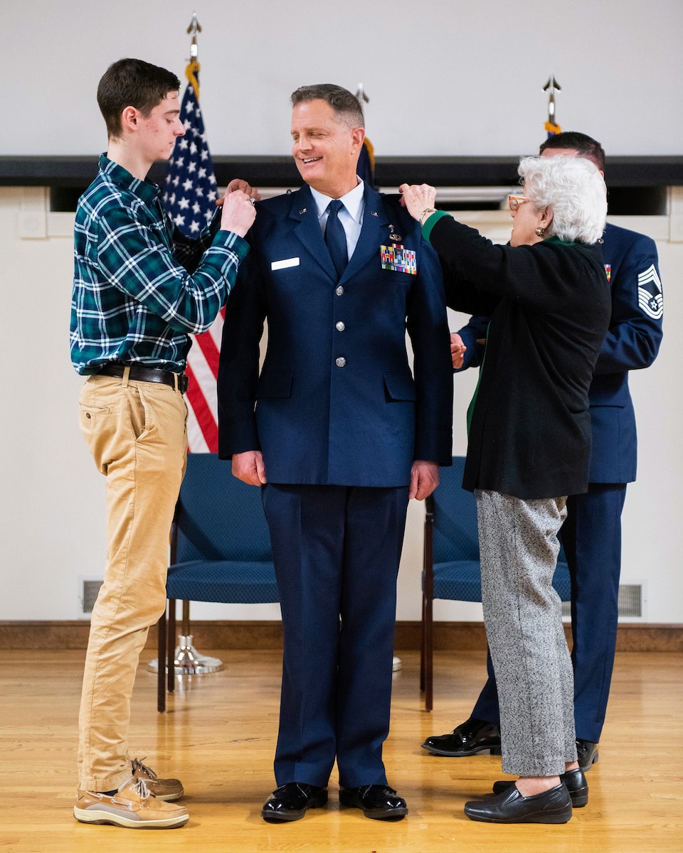 Chaplain Fred Ehrman is promoted to the rank of colonel with the help of family members during a ceremony at the Kentucky Air National Guard Base in Louisville, Ky., Jan. 5, 2019. Ehrman, who previously served as chaplain at the Kentucky Air Guard's 123rd Airlift Wing, is now Air National Guard assistant to the chaplain, U.S. Air Forces Europe and Air Forces Africa. (U.S. Air National Guard photo by Master Sgt. Vicky Spesard)