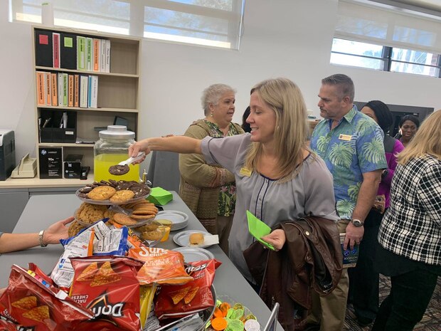 Patrons and employees of the Joint Base Charleston Air Base Library enjoy a tour of the newly renovated library as well as snacks and social time. The just reopened Air Base Library has been upgraded with new carpet, paint and furniture and will be more flexible not only for readers, but for events to be held at the facility. The renovation was part of an Air Force initiative  to modernize base libraries.