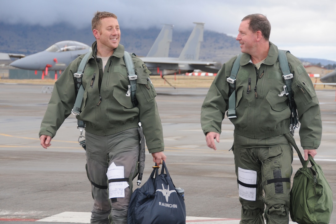 Two men walk on flight line