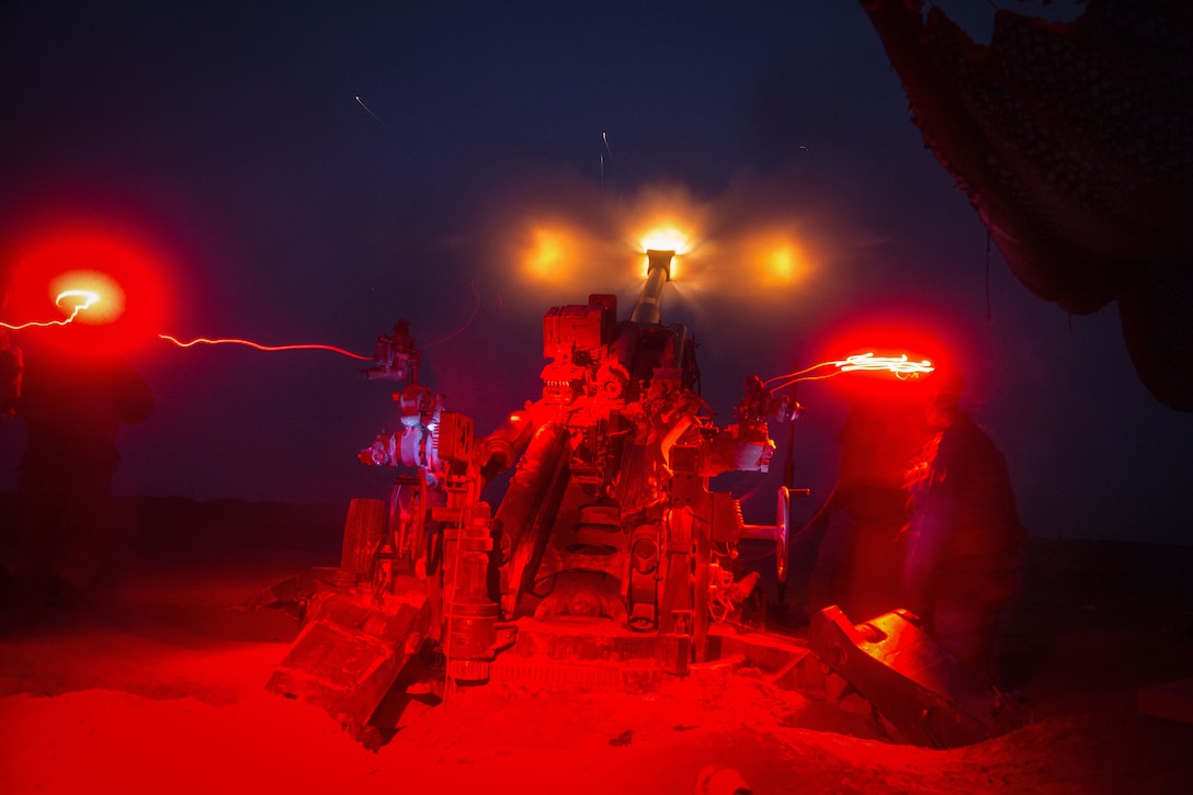 Artillery piece fires at night
