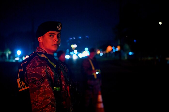 Senior Airman Joe Serna, 628th Security Forces Squadron patrolman, waits for a car during a DUI checkpoint Feb. 3, 2019, at Joint Base Charleston, S.C.