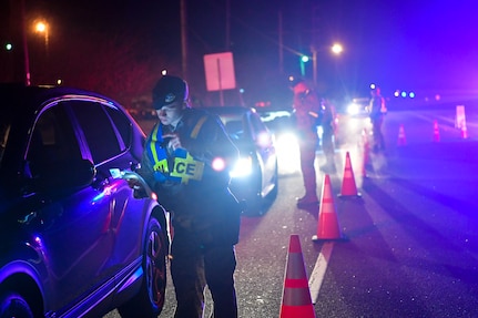 628th Security Forces Squadron patrolmen check drivers’ insurance and registration during a DUI checkpoint Feb. 3, 2019, at Joint Base Charleston, S.C.