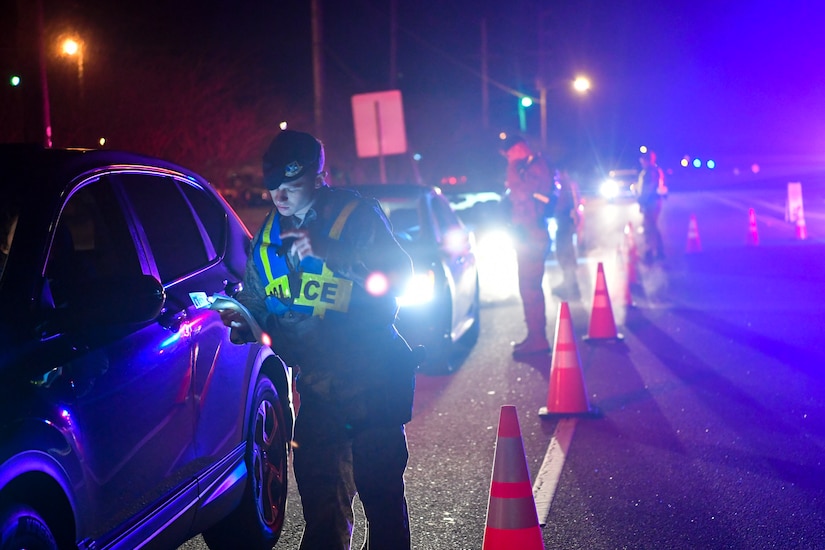 628th Security Forces Squadron patrolmen check drivers’ insurance and registration during a DUI checkpoint Feb. 3, 2019, at Joint Base Charleston, S.C.