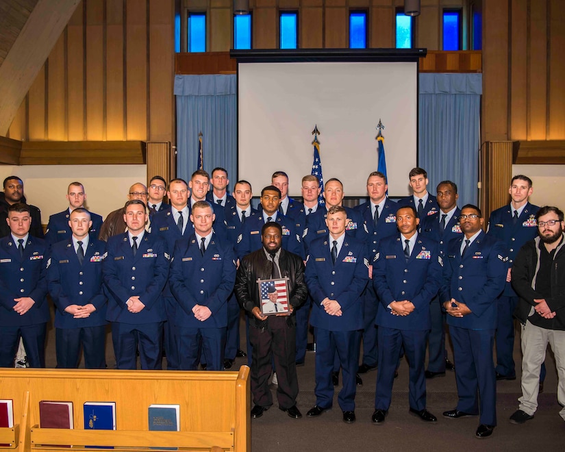 Members of the “Dirt Boyz” of the 633rd Civil Engineer Squadron pose with a photograph of U.S. Air Force Tech. Sgt. Jason Kelley, 633rd CES NCO in charge of pavements and equipment, during Kelley’s funeral service at Bethel Chapel at Joint Base Langley-Eustis, Virginia, Jan. 21, 2019. Dirt Boyz attended the funeral to show support for the family of the man they worked alongside throughout his cancer treatment and his career in the U.S. Air Force. (U.S. Air Force photo by Airman 1st Class Marcus M. Bullock)