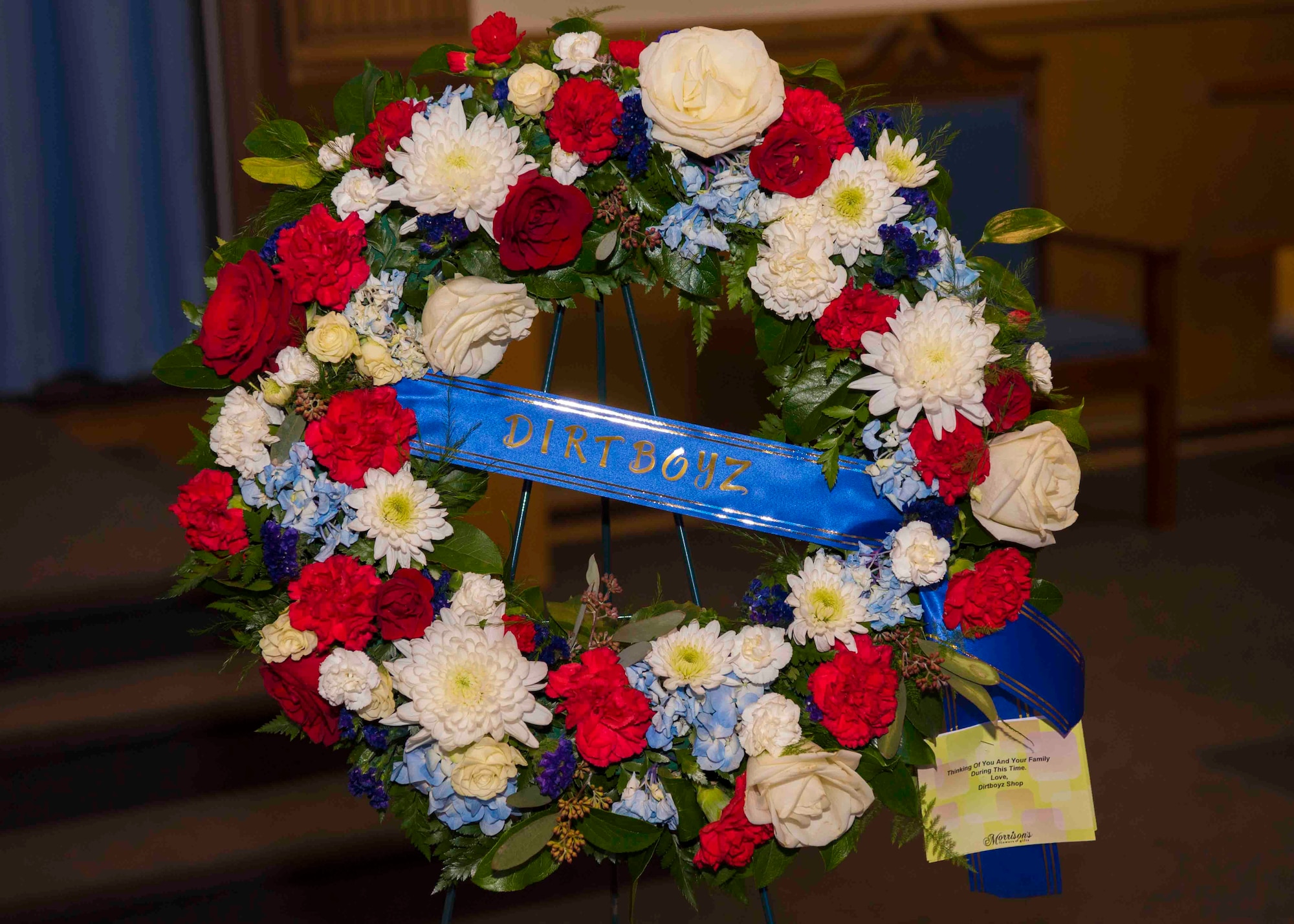 A wreath from the “Dirt Boyz” of the 633rd Civil Engineer Squadron sits on display at Bethel Chapel during the funeral service of U.S. Air Force Tech. Sgt. Jason Kelley, 633rd CES NCO in charge of pavements and equipment at Joint Base Langley-Eustis, Virginia, Jan. 21, 2019,. Kelley, who was part of the Dirt Boyz, passed away after a two-year battle with stage four esophageal cancer. (U.S. Air Force photo by Airman 1st Class Marcus M. Bullock)