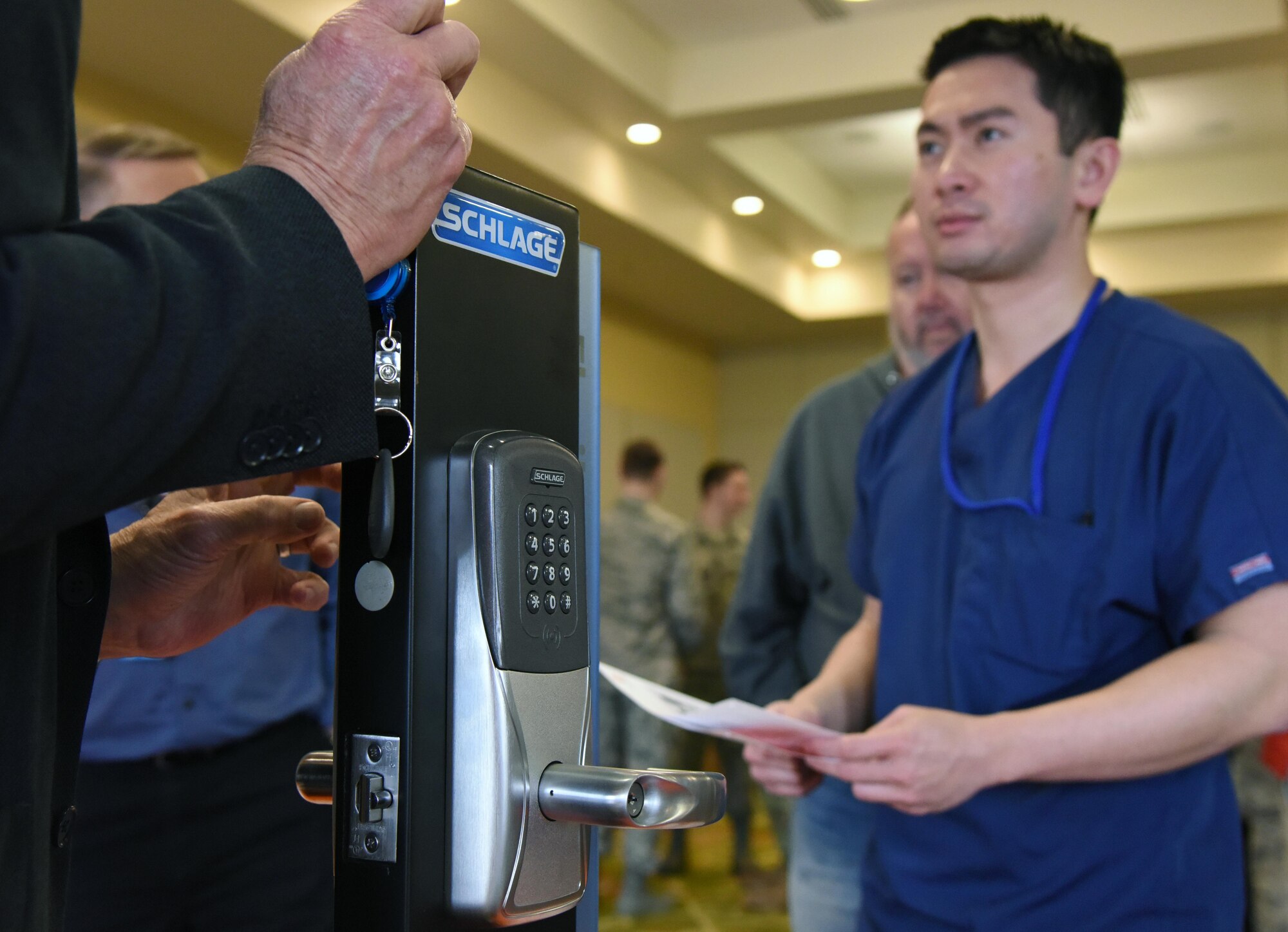 Johnny Truong, VA Hospital chiropractor, watches a demonstration on a common access card lock given by Terry Collins, Allegion government sales director, during the Annual Keesler Air Force Base Tech Expo inside the Bay Breeze Event Center at Keesler Air Force Base, Mississippi, Feb. 5, 2019. The expo was hosted by the 81st Communications Squadron and was free to all Defense Department, government and contractor personnel with base access. U.S. Air Force Maj. Jon Drummond, 81st CS commander, said events like this allows us to see the local vendors' newest technologies and find opportunities to branch that technology with Keesler's training mission. The event was held to introduce military members to the latest in technological advancements to bolster the Air Force's capabilities in national defense. (U.S. Air Force photo by Kemberly Groue)