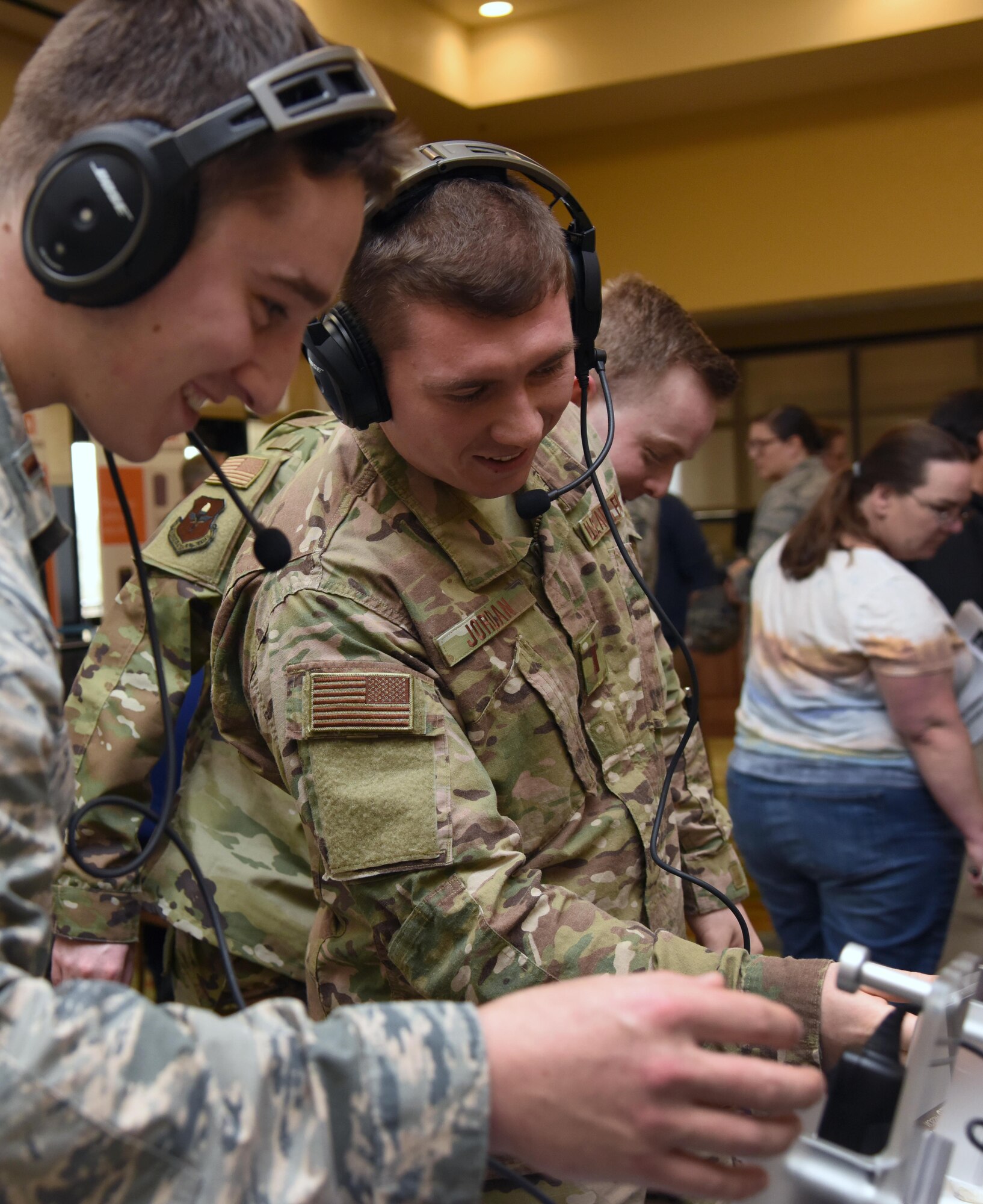 U.S. Air Force 2nd Lts. Steven Call and Taylor Jordan, 333rd Training Squadron students, test out Bose aviation headsets during the Annual Keesler Air Force Base Tech Expo inside the Bay Breeze Event Center at Keesler Air Force Base, Mississippi, Feb. 5, 2019. The expo was hosted by the 81st Communications Squadron and was free to all Defense Department, government and contractor personnel with base access. U.S. Air Force Maj. Jon Drummond, 81st CS commander, said events like this allows us to see the local vendors' newest technologies and find opportunities to branch that technology with Keesler's training mission. The event was held to introduce military members to the latest in technological advancements to bolster the Air Force's capabilities in national defense. (U.S. Air Force photo by Kemberly Groue)