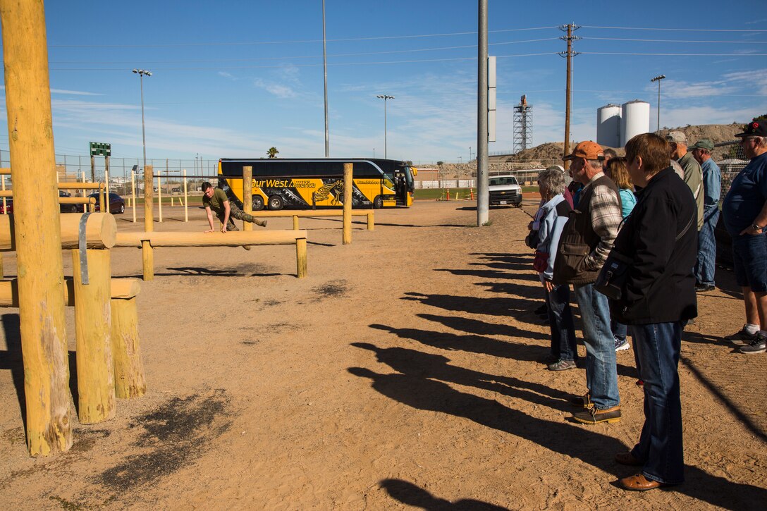 Guests participating in the Marine Corps Air Station (MCAS) Yuma Winter Tours observe a demonstration of the obstacle course, the Marine Corps Martial Arts Program (MCMAP), and a military working dog demonstration at various locations on MCAS Yuma, Ariz., Jan.9, 2019. Col. David A. Suggs, the station commanding officer, resumed the tours in 2018 to strengthen the relationship with the outside community and give them the opportunity to see what the Marines aboard the air station do. (U.S. Marine Corps photo taken by Cpl. Isaac D. Martinez)