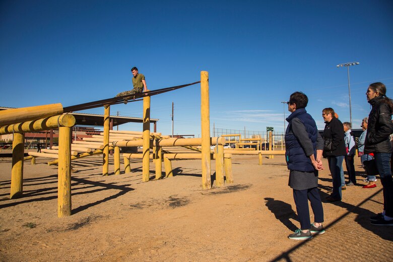 Guests participating in the Marine Corps Air Station (MCAS) Yuma Winter Tours observe a demonstration of the obstacle course, the Marine Corps Martial Arts Program (MCMAP), and a military working dog demonstration at various locations on MCAS Yuma, Ariz., Jan.9, 2019. Col. David A. Suggs, the station commanding officer, resumed the tours in 2018 to strengthen the relationship with the outside community and give them the opportunity to see what the Marines aboard the air station do. (U.S. Marine Corps photo taken by Cpl. Isaac D. Martinez)