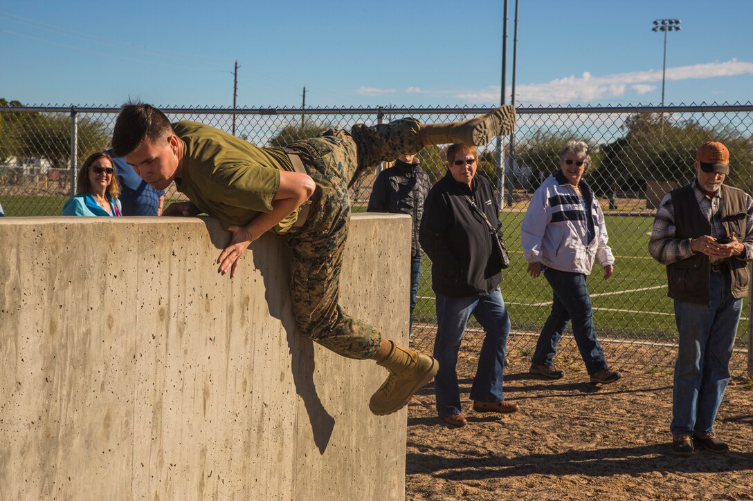 Guests participating in the Marine Corps Air Station (MCAS) Yuma Winter Tours observe a demonstration of the obstacle course, the Marine Corps Martial Arts Program (MCMAP), and a military working dog demonstration at various locations on MCAS Yuma, Ariz., Jan.9, 2019. Col. David A. Suggs, the station commanding officer, resumed the tours in 2018 to strengthen the relationship with the outside community and give them the opportunity to see what the Marines aboard the air station do. (U.S. Marine Corps photo taken by Cpl. Isaac D. Martinez)