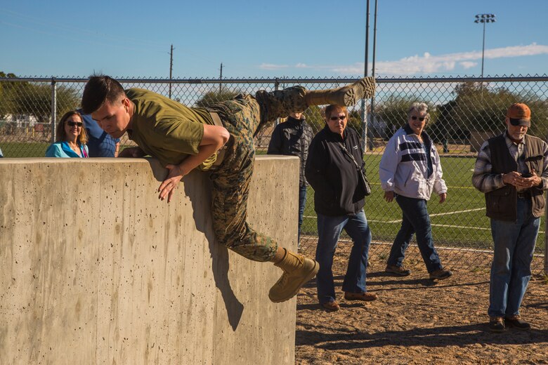 Guests participating in the Marine Corps Air Station (MCAS) Yuma Winter Tours observe a demonstration of the obstacle course, the Marine Corps Martial Arts Program (MCMAP), and a military working dog demonstration at various locations on MCAS Yuma, Ariz., Jan.9, 2019. Col. David A. Suggs, the station commanding officer, resumed the tours in 2018 to strengthen the relationship with the outside community and give them the opportunity to see what the Marines aboard the air station do. (U.S. Marine Corps photo taken by Cpl. Isaac D. Martinez)