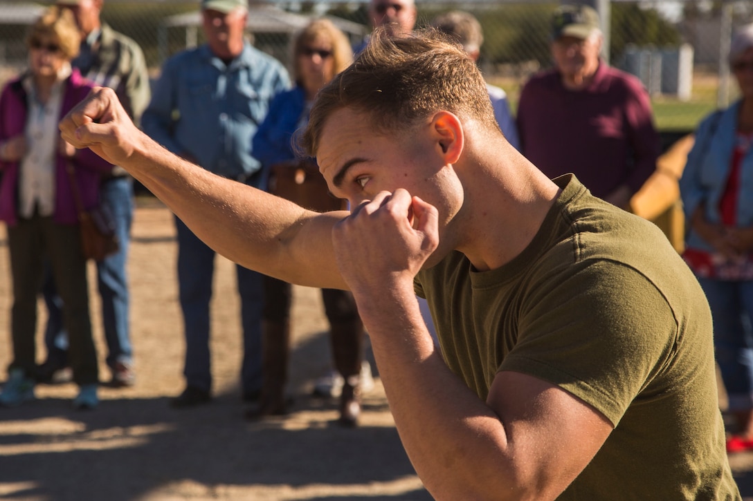 Guests participating in the Marine Corps Air Station (MCAS) Yuma Winter Tours observe a demonstration of the obstacle course, the Marine Corps Martial Arts Program (MCMAP), and a military working dog demonstration at various locations on MCAS Yuma, Ariz., Jan.9, 2019. Col. David A. Suggs, the station commanding officer, resumed the tours in 2018 to strengthen the relationship with the outside community and give them the opportunity to see what the Marines aboard the air station do. (U.S. Marine Corps photo taken by Cpl. Isaac D. Martinez)
