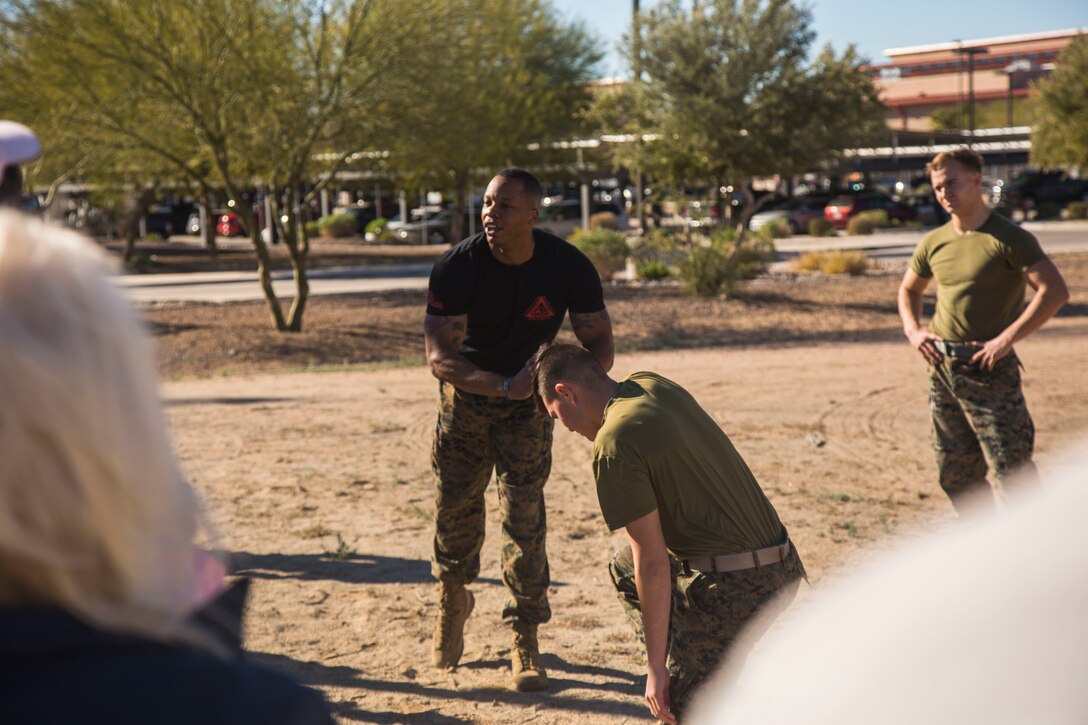 Guests participating in the Marine Corps Air Station (MCAS) Yuma Winter Tours observe a demonstration of the obstacle course, the Marine Corps Martial Arts Program (MCMAP), and a military working dog demonstration at various locations on MCAS Yuma, Ariz., Jan.9, 2019. Col. David A. Suggs, the station commanding officer, resumed the tours in 2018 to strengthen the relationship with the outside community and give them the opportunity to see what the Marines aboard the air station do. (U.S. Marine Corps photo taken by Cpl. Isaac D. Martinez)