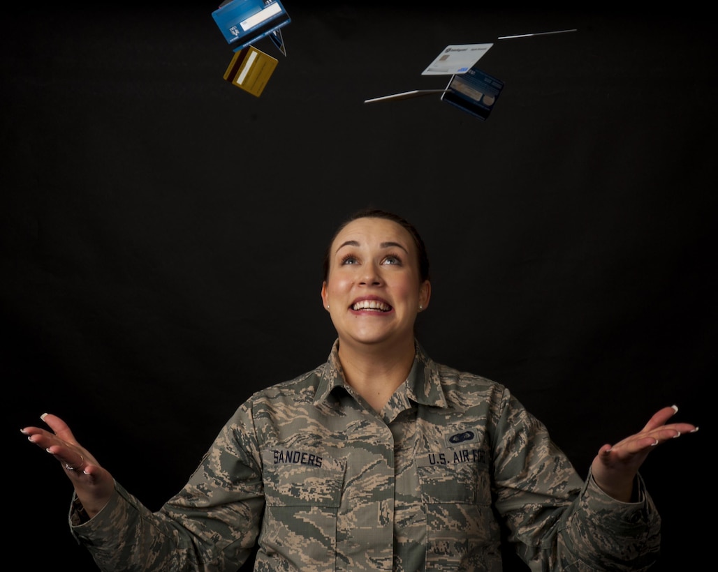 In this photo illustration, Staff Sgt. Kya Sanders, 90th Security Support Squadron administration, tosses away credit cards, symbolizing the credit card debt she and her fellow Financial Peace University graduates eliminated and the credit card offers they turned down during the 12-week course. The FPU course hosted by the 90th Missile Wing chapel follows financial author and spokesman Dave Ramsey's "Financial Peace Military" curriculum, which is similar to the standard FPU course, but with an emphasis on military-specific financial topics. (U.S. Air Force photo illustration by Senior Airman Jason Wiese)