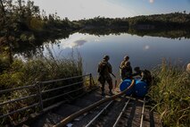 Marines with 2nd Platoon, Bulk Fuel Company, 9th Engineer Support Battalion, 3rd Marine Logistics Group, tie a suction hose to barrels on Jan. 28, 2019 at Central Training Area, Camp Hansen, Okinawa, Japan. Bulk fuel specialists assembled several fuel sites across the CTA to enhance their training and readiness within a harsh environment. The Marines set up and maintained their bulk fuel equipment during a week-long training evolution. (U.S. Marine Corps photo by Lance Cpl. Armando Elizalde)