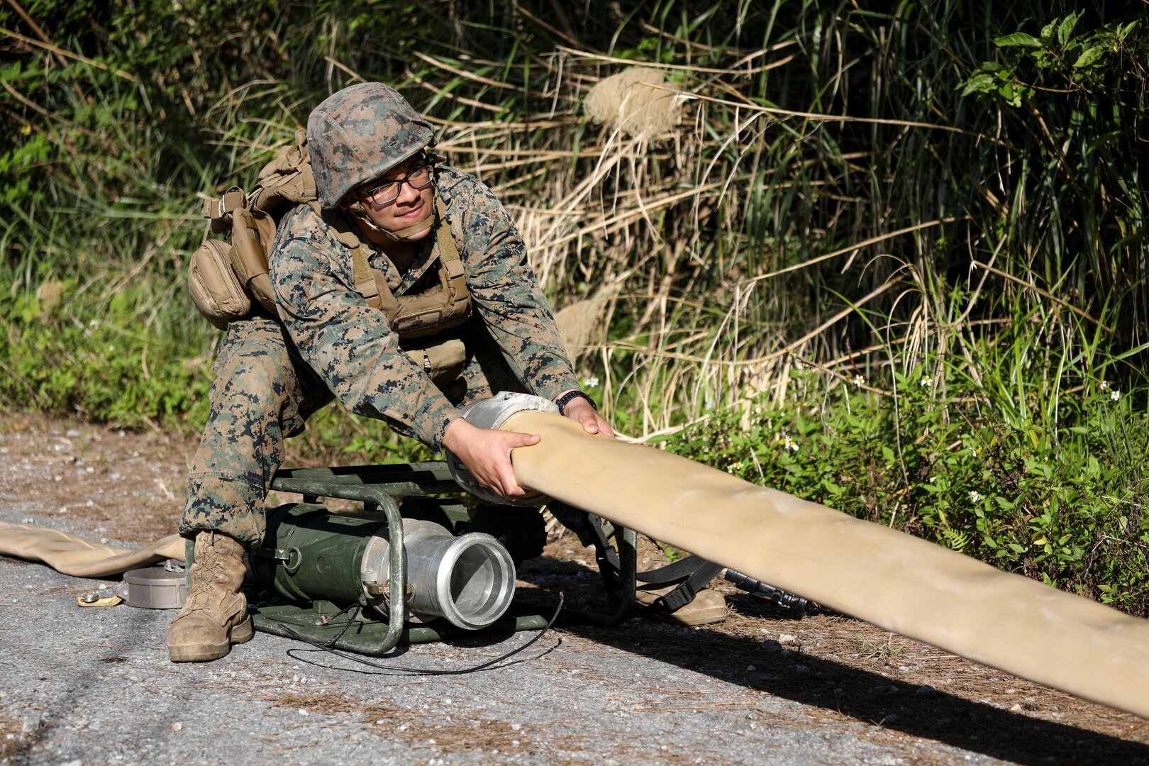 Pfc. Gilberto Loza-Machado pulls on a fuel hose to be attached to a meter on Jan. 28, 2019 at Central Training Area, Camp Hansen, Okinawa, Japan. Marines with 2nd Platoon, Bulk Fuel Company, 9th Engineer Support Battalion, 3rd Marine Logistics Group, assembled several fuel sites across the CTA to enhance their training and readiness within a harsh environment. The Marines set up and maintained their bulk fuel equipment during a week-long training evolution. Loza-Machado, a native of San Bernardino, California, is a bulk fuel specialist with 2nd Plt., Bulk Fuel Co., 9th ESB, 3rd MLG. (U.S. Marine Corps photo by Lance Cpl. Armando Elizalde)