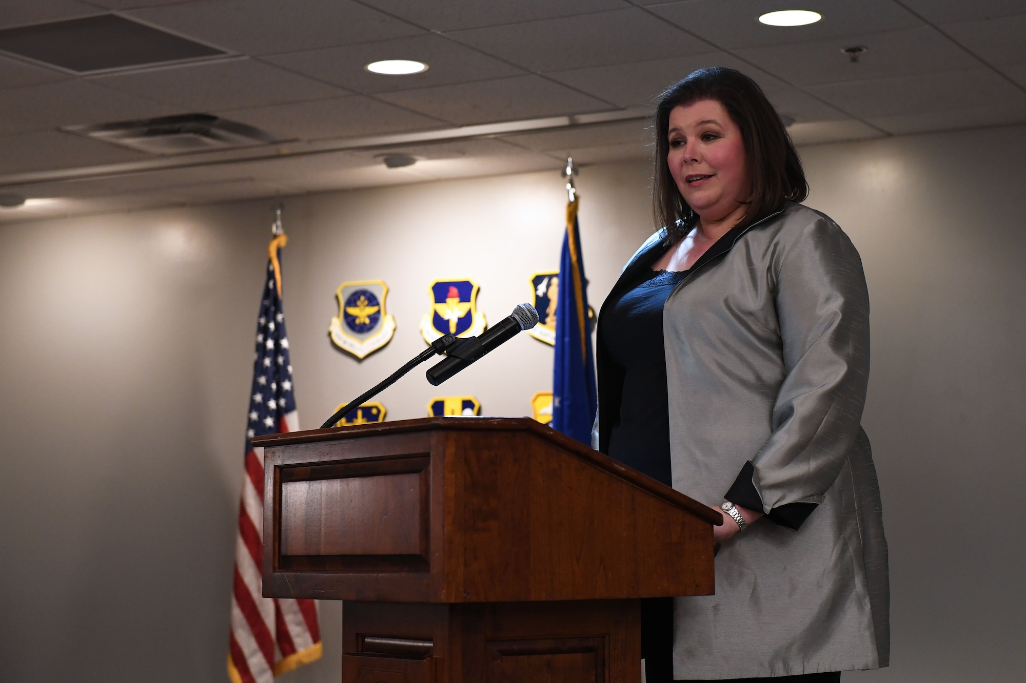 A woman stands a podium.