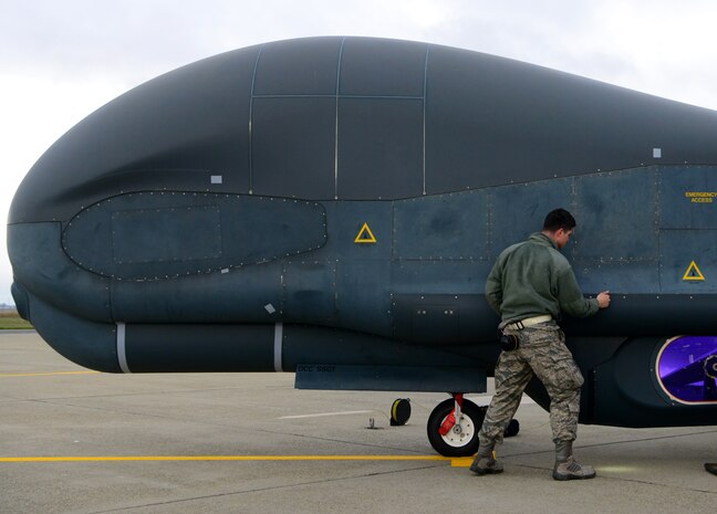 Staff Sgt. Seth Thurber, 69th Maintenance Squadron Detachment 1 RQ-4 Global Hawk avionics technician, checks panels during a preflight inspection