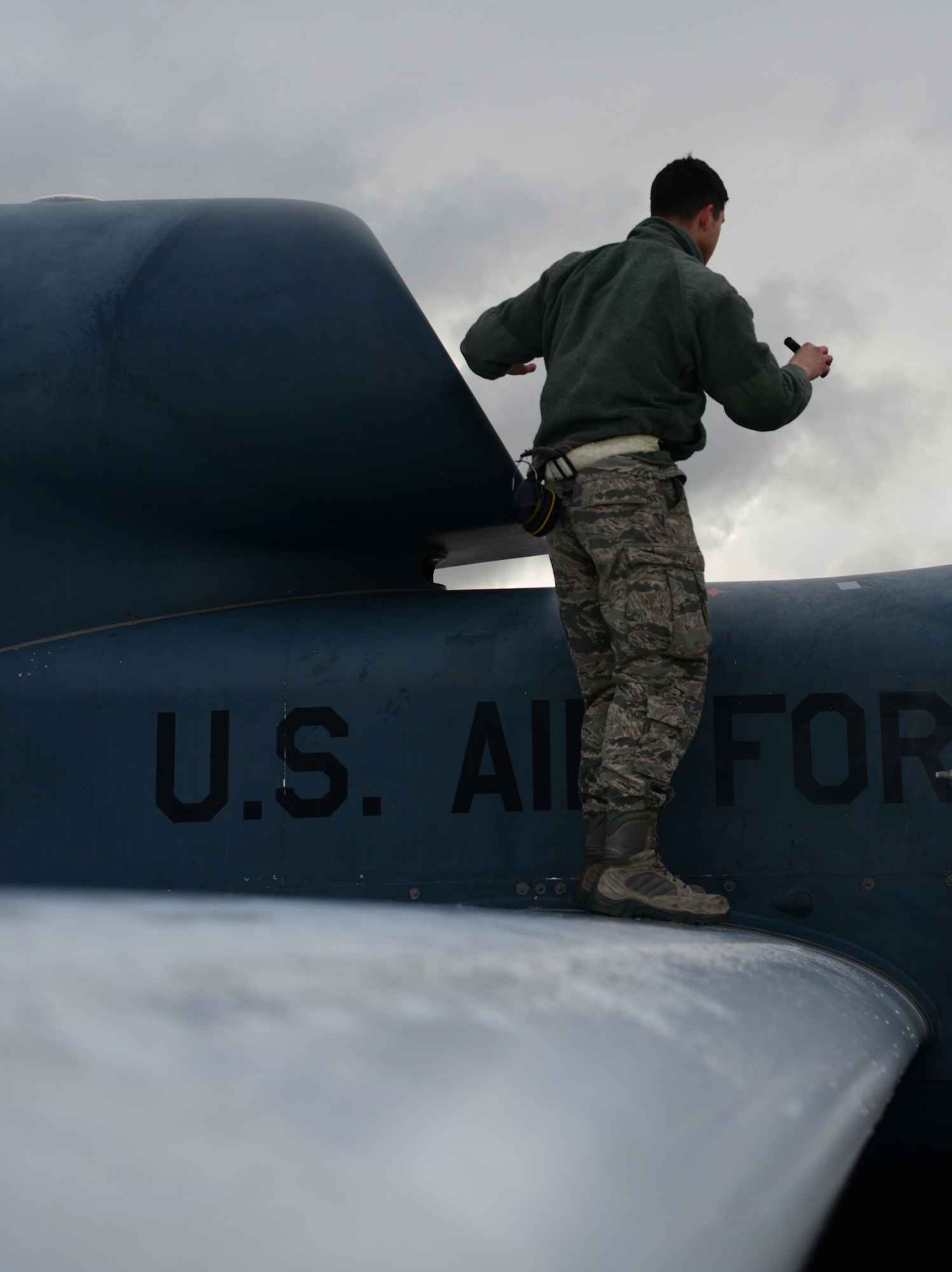 Staff Sgt. Seth Thurber, 69th Maintenance Squadron Detachment 1 RQ-4 Global Hawk avionics technician, stands on a wing during a preflight inspection