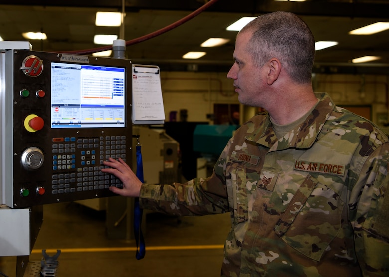 Tech Sgt. Robert Burns, 56th Equipment Maintenance Squadron aircraft metals technology non-commissioned officer in charge, inputs a command into a 5-axis computer numerical control machine, Feb. 6, 2019 at Luke Air Force Base, Ariz.