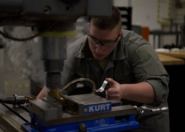 Airman 1st Class Taylor Frost, 56th Equipment Maintenance Squadron aircraft metals technology apprentice, shaves down an ammunition shell, Feb. 6, 2019 at Luke Air Force Base, Ariz.