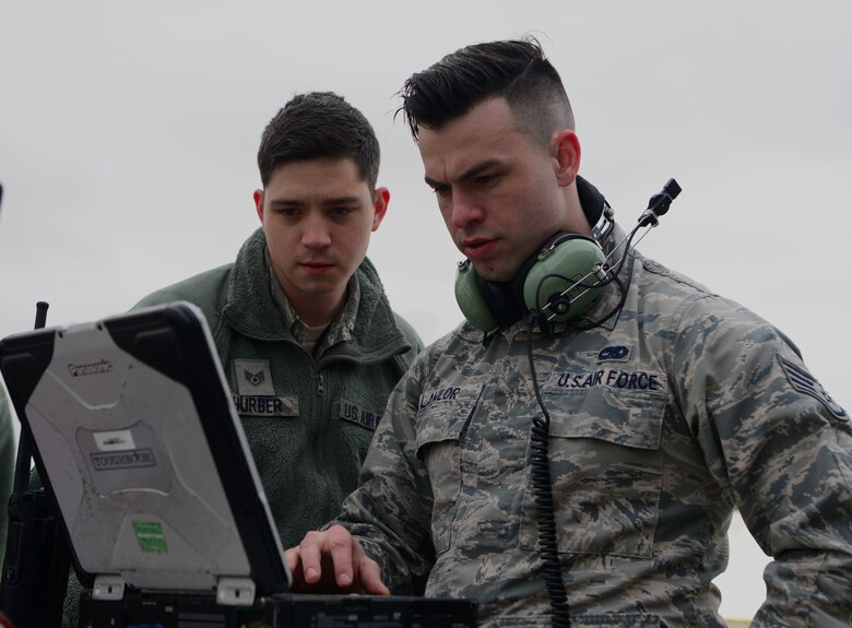 1 RQ-4 avionics technicians review a maintenance technical order