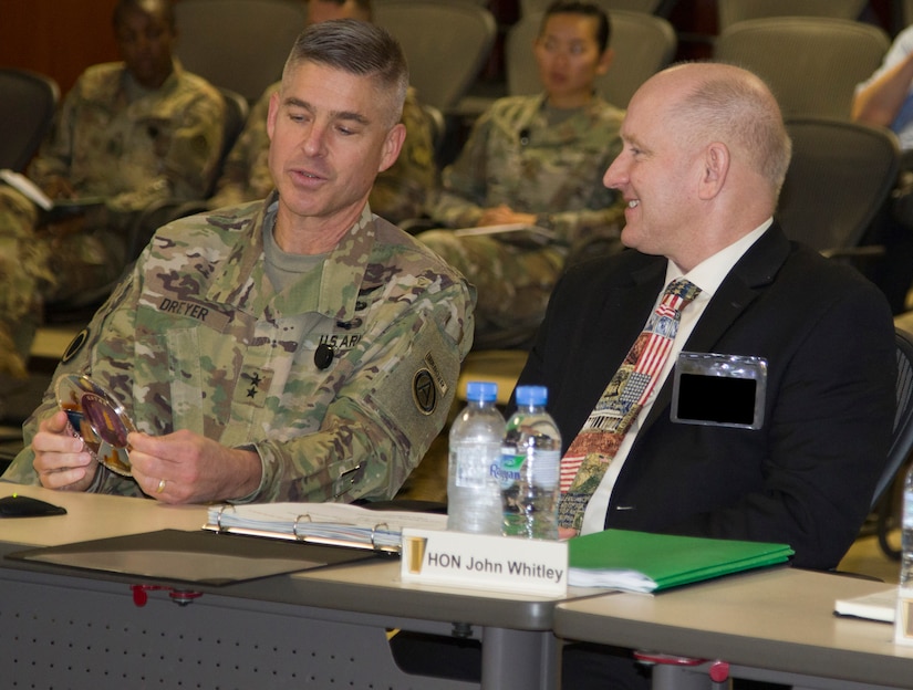 U.S. Army Maj. Gen. Brad K. Dreyer, the U.S. Army Central Finance Management assistant chief of staff, presents a token of appreciation to the Honorable John E. Whitley, the Assistant Secretary of the Army for Financial Management and Comptroller, during the U.S. ARCENT Financial Management and Comptroller Forum at Al Udeid Air Base, Qatar, Dec. 3, 2018. This was Whitley's first time in attendance at the annual forum and plans to use this opportunity to improve theater-wide financial decisions.