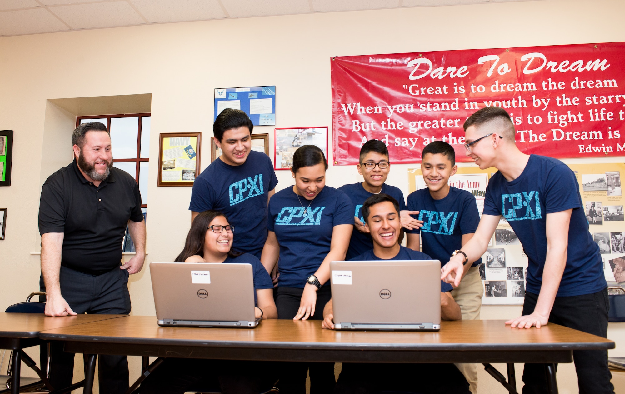 Thomas Jefferson High school Army Junior ROTC CyberPatriot team members get some coaching from George Cue, an employee with 25th Air Force’s 625th Operations Center. During their Jan. 31, 2019 meeting, the team discusses the challenges they will face as they advance forward to the gold and platinum rounds of this year’s competition. (U.S Air Force photo by Sharon Singleton)