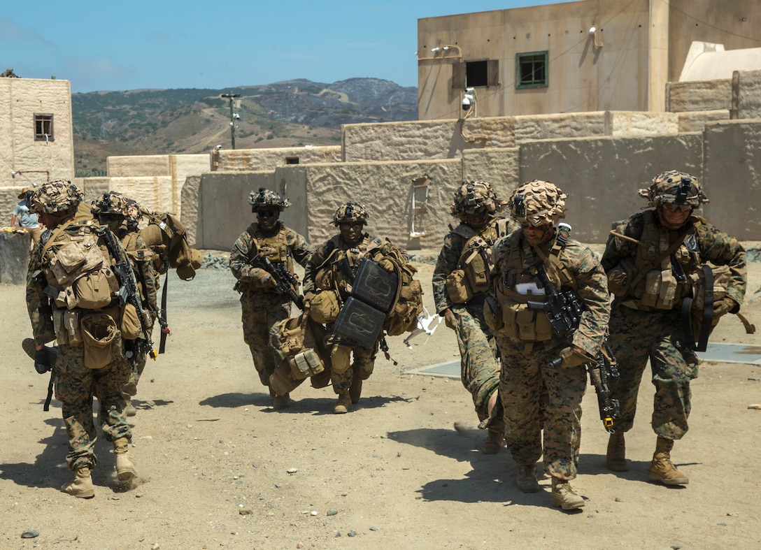 U.S. Marines with Echo Company, 2nd Battalion, 4th Marine Regiment, 1st Marine Division, carry injured Marines to the casualty collection point during Prime Time Training, at the Infantry Immersion Trainer (IIT) facility, Marine Corps Base Camp Pendleton, Calif., July 23, 2017.