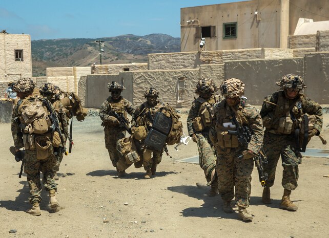 U.S. Marines with Echo Company, 2nd Battalion, 4th Marine Regiment, 1st Marine Division, carry injured Marines to the casualty collection point during Prime Time Training, at the Infantry Immersion Trainer (IIT) facility, Marine Corps Base Camp Pendleton, Calif., July 23, 2017.