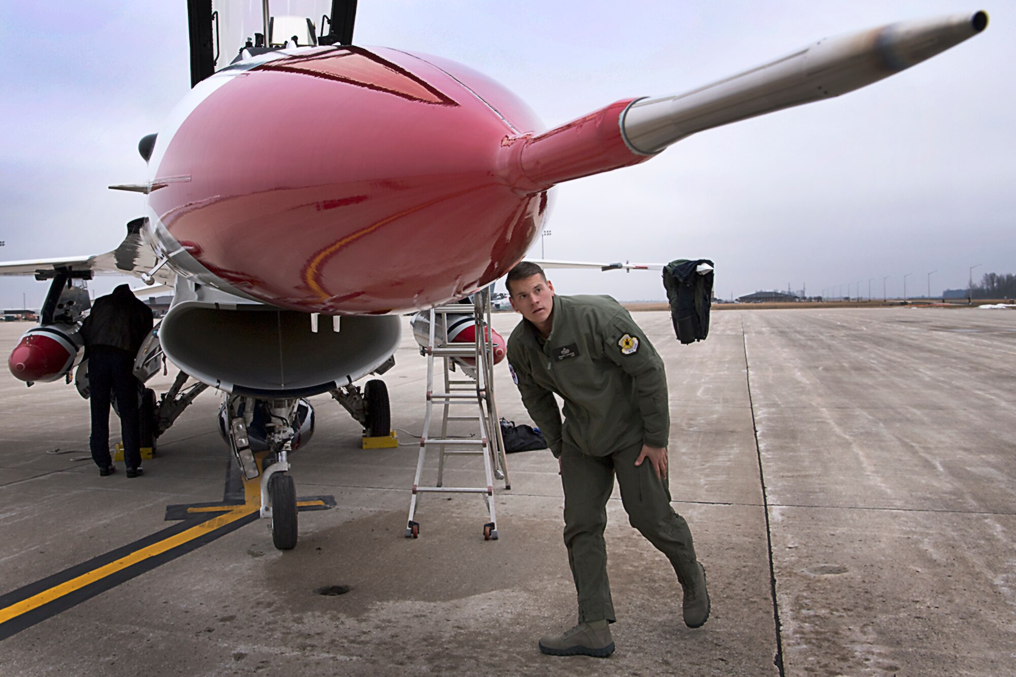 Tech. Sgt. Bryson Schuster, Thunderbird crew chief and maintenance team advance member, does a post-flight inspection upon landing at Grissom Air Reserve Base, Ind., Feb. 5, 2019. Schuster visited and spoke with maintenance team members and toured facilities prior to the team’s arrival for the Grissom Air and Space Expo scheduled for Sept. 7-8, 2019. (U.S. Air Force photo/Douglas Hays