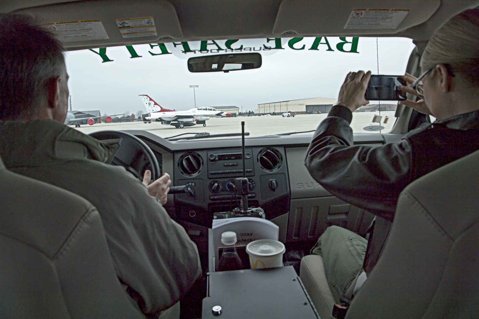Lt. Col. Billy Werth, left, and Master Sgt. Deborah Wood, both airshow planning team members, follow Thunderbird 8 as it taxis to a parking spot at Grissom Air Reserve Base, Ind., Feb. 5, 2019. Thunderbird team members Maj. Jason Markzon, and Tech Sgt. Bryson Schuster, visited the base for a site visit and overview as preparations build for the Grissom Air and Space Expo scheduled for Sept. 7-8. (U.S. Air Force photo/Douglas Hays)