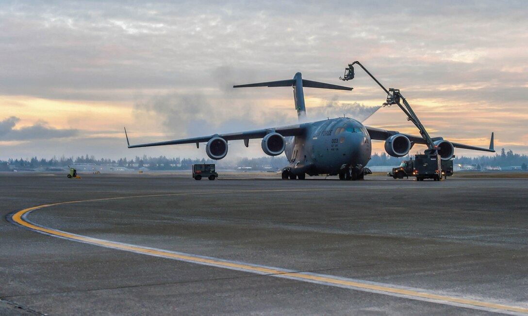 Airmen assigned to the 62nd Aircraft Maintenance Squadron spray a C-17 Globemaster III with deicing liquid at Joint Base Lewis-McChord, Wash., Jan. 16, 2019. Ice and snow on the flight control surfaces, such as the tail and wings, can introduce unknown aerodynamic characteristics that may render the aircraft unsafe for takeoff. (U.S. Air Force photo by Senior Airman Tryphena Mayhugh)