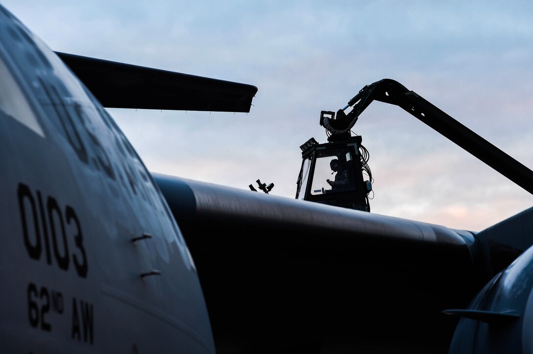 Senior Airman Dakota Crites, 62nd Aircraft Maintenance Squadron integrated flight control systems specialist, prepares to spray a C-17 Globemaster III with deicing liquid at Joint Base Lewis-McChord, Wash., Jan. 16, 2019. Crites and other 62nd AMXS Airmen deice aircraft throughout the winter months to ensure jets are safe to fly. (U.S. Air Force photo by Senior Airman Tryphena Mayhugh)