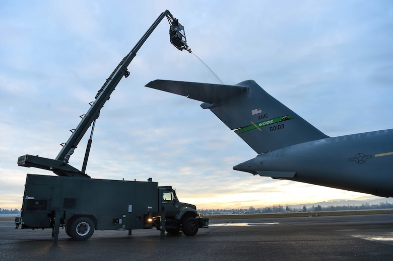 Senior Airman Dakota Crites, 62nd Aircraft Maintenance Squadron integrated flight control systems specialist, sprays the tail of a C-17 Globemaster III with deicing liquid at Joint Base Lewis-McChord, Wash., Jan. 16, 2019. When needed, an aircraft must be deiced four hours before take-off when the weather reaches freezing temperatures in order to be safe to fly. (U.S. Air Force photo by Senior Airman Tryphena Mayhugh)